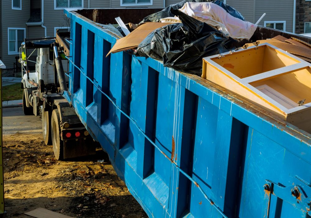 Dumpster, recycle waste and garbage bins near new construction of appartment houses building